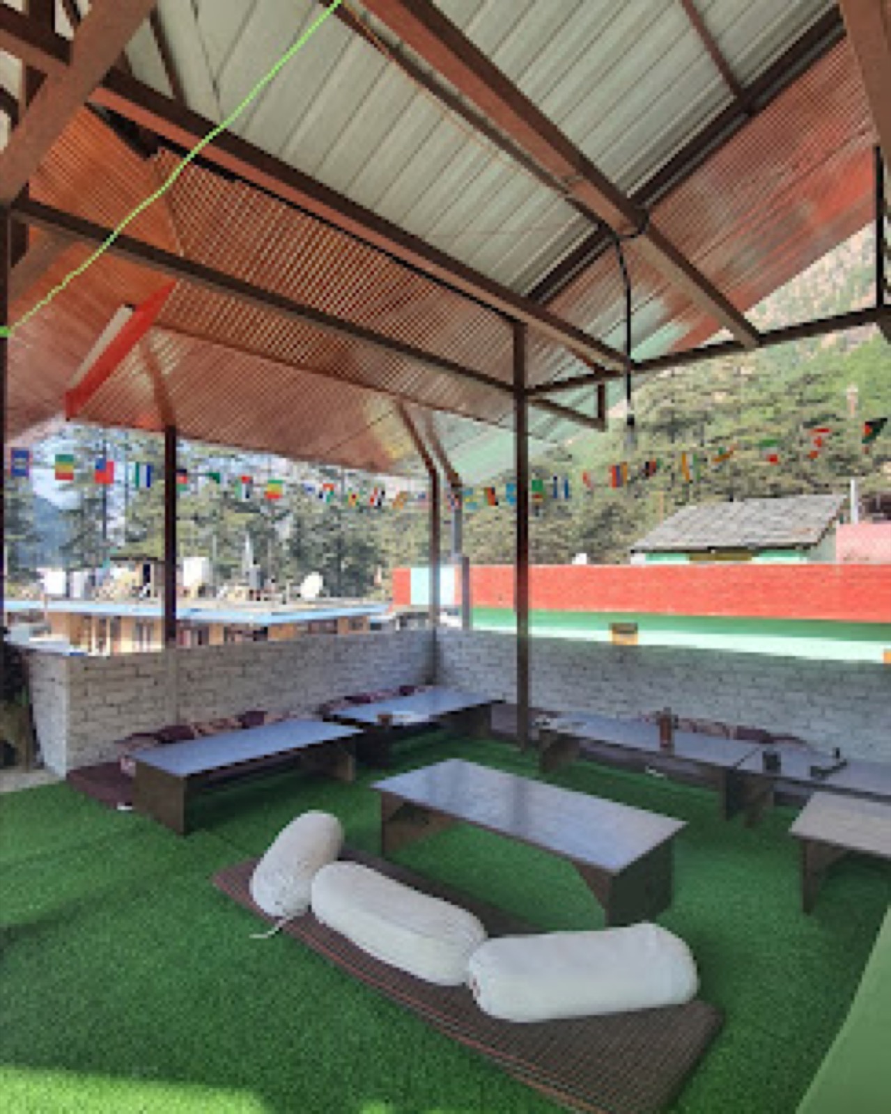 Open-air terrace lounge at Sood Homestay in Kasol with low seating and mountain-facing views